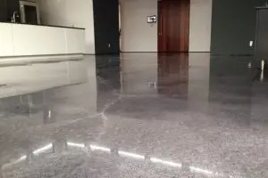 High-gloss polished concrete floor with smooth, reflective finish installed by DecoCrete Services